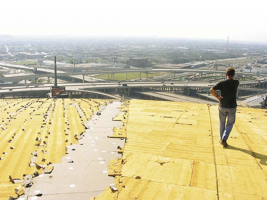 Thornton Tomasetti surveys wind damage from Hurricane Katrina, which exposed insulation (in yellow) on the roof of the Superdome. 