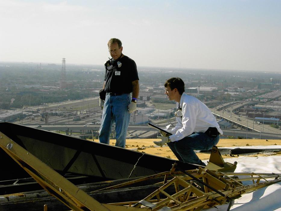Assessing roof damage from Hurricane Katrina in New Orleans, Louisiana. 
