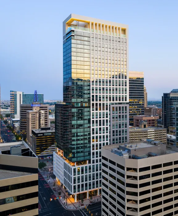 The structural system uses post-tensioned concrete slabs and columns, with concrete shear walls at the core and stairways for lateral support.