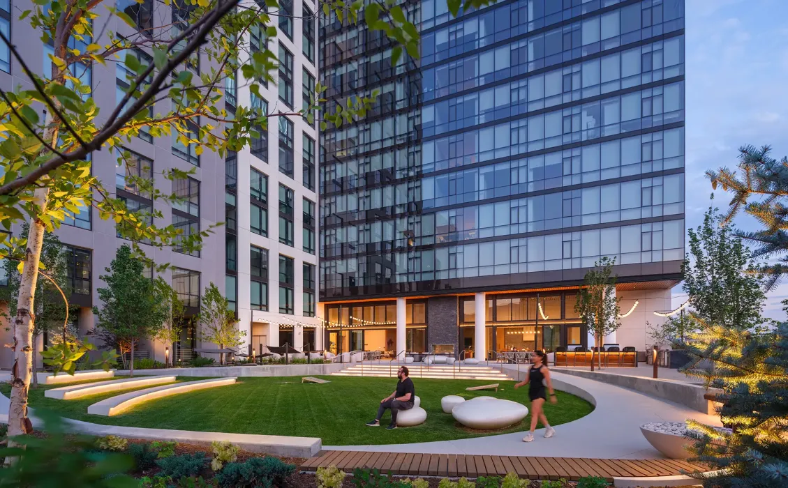 The structural system uses post-tensioned concrete slabs and columns, with concrete shear walls at the core and stairways for lateral support.