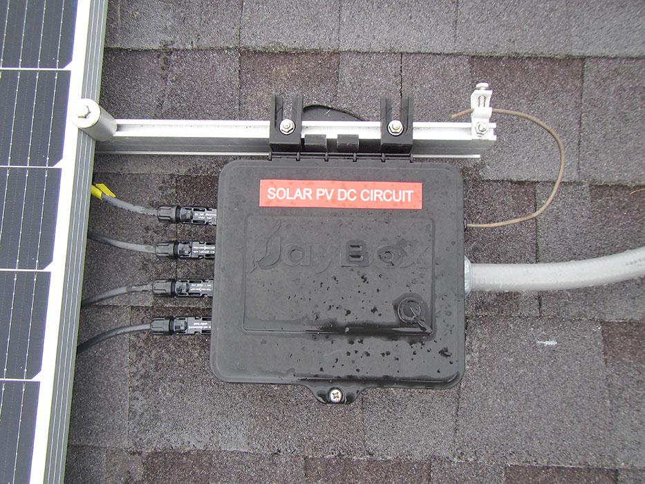 Solar panels and HVAC units are on the roof, and the building was nearing completion but not yet occupied.