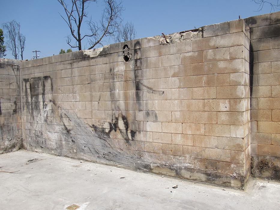 CMU basement walls displayed significant damage, including large vertical cracks, spalled face shells and extensive surface abrasion.