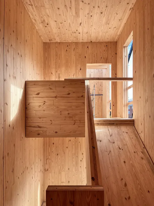 A dropped girder system – with the upper glulam beam supporting the CLT floor plate and a lower, dropped beam supporting the beam above – reduces the cost of girder-to-column connections and creates a gap between the dropped beam and the CLT floor that allows routing of MEP systems with fewer penetrations through the beams. 