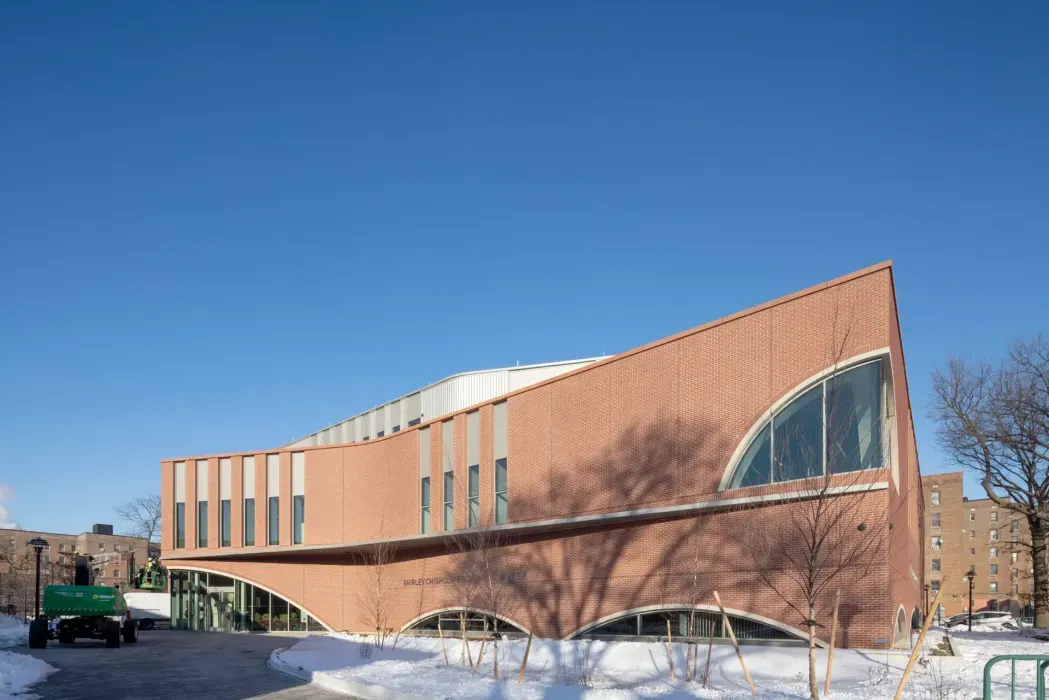 The article highlights the project’s role as a new civic hub and its use of mass timber, which supports both sustainability goals and a warm, community-oriented interior environment.