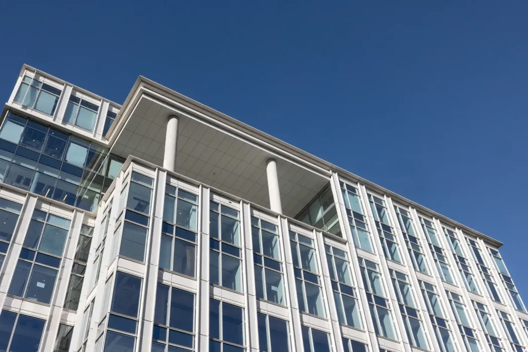 The existing roof and penthouse roof slabs were removed, and three new occupiable floors are being added to the top of the building.