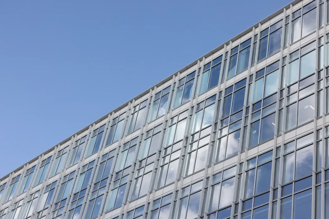 The structural scope included extensive modifications to the existing post-tensioned floor slabs and enlargement of concrete columns to accommodate new two-story retail spaces.