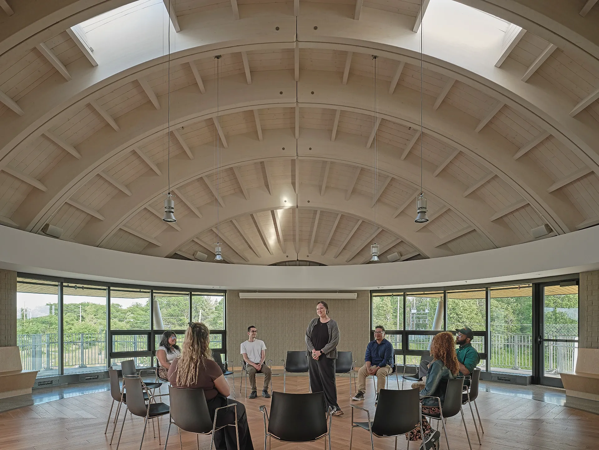 Designed by Formline Architecture + Urbanism in association with LGA Architectural Partners, the building includes spaces for ceremonies, classes, exhibitions, research, and community gatherings. Its round gathering spaces are topped by curving grids of glue-laminated timber inspired by traditional bentwood construction. 