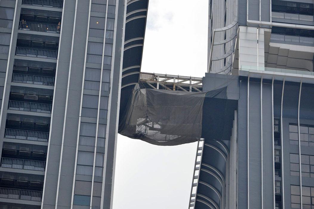 Visible damage to the skybridge between Buildings B and C.