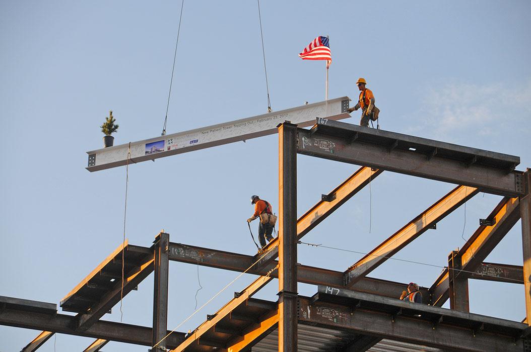 Construction workers place the final structural steel beam on the New Patient Tower at Torrance Memorial Medical Center during a Topping Out ceremony in 2012.