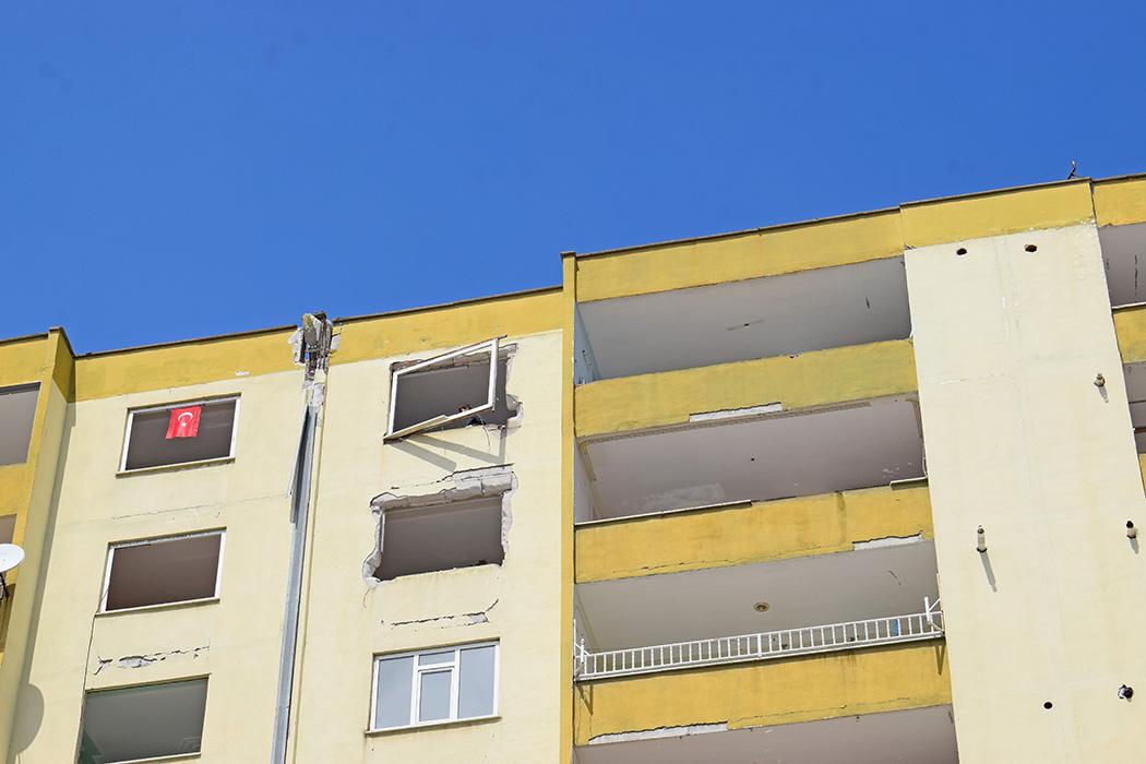 A window frame being removed from a 12-story building set for demolition. People were salvaging building materials prior to demolition and then selling them for a profit.