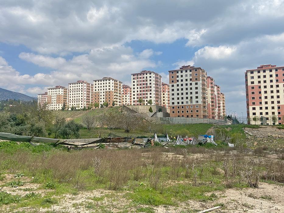 A housing development constructed in 2014 with multiple 12-story buildings awaiting demolition in Kahramanmaraş. The buildings suffered moderate structural damage as intended per modern building codes used worldwide. 