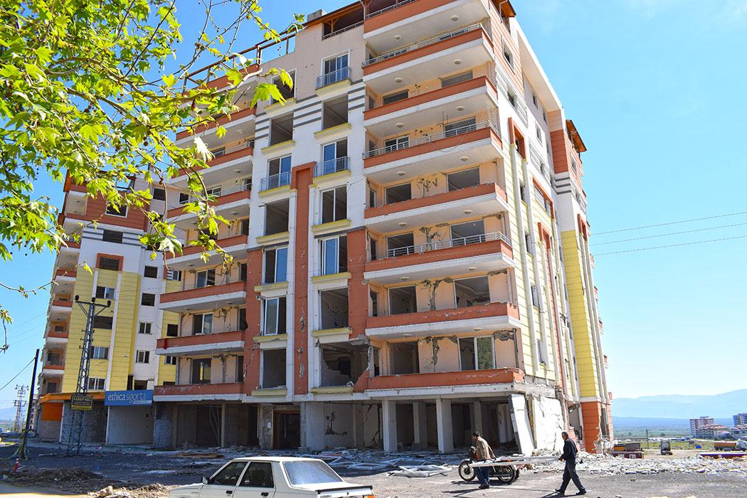 Across the street from the preceding photo, a residential building, also post-2000, with significant permanent drift and extensive structural and non-structural damage.