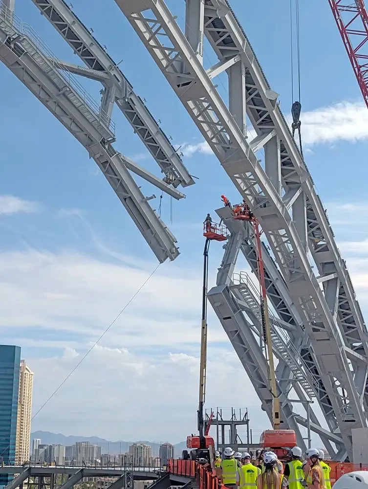 The ballpark’s long-span roof features five overlapping curved surfaces inspired by baseball pennants and supported by freestanding steel arch trusses. When complete, the roof structure will rise 290 feet above the playing field.